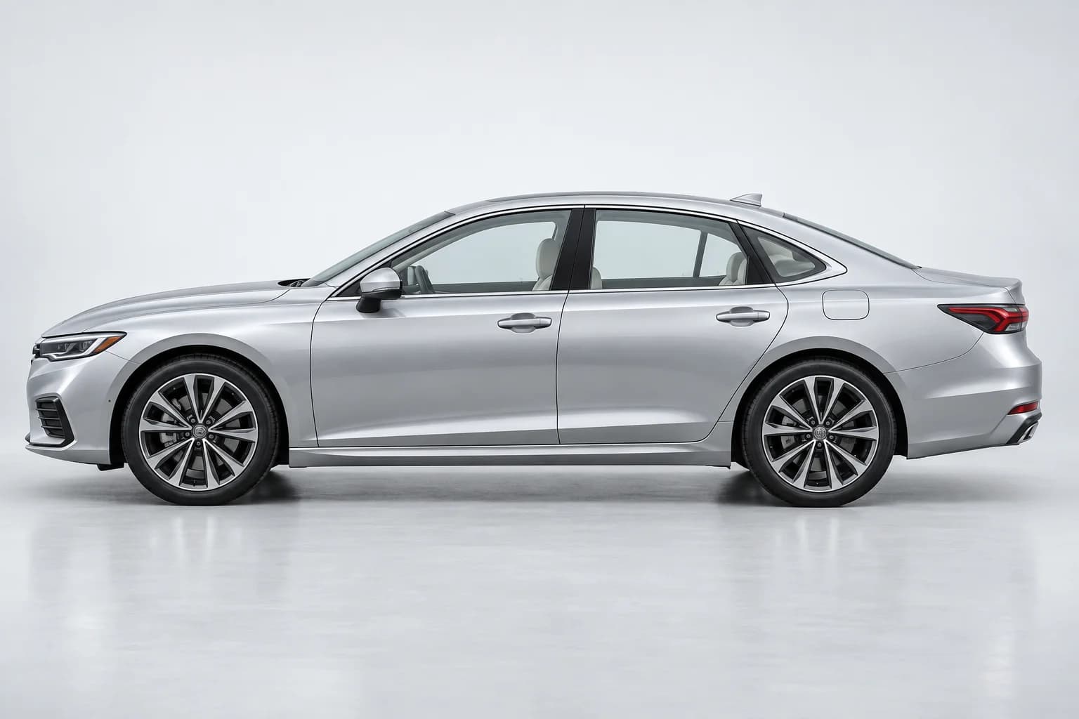 Full side profile of an unbranded silver car in a bright studio.